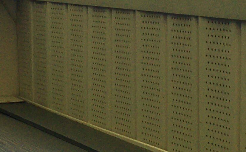 Perforated metal soffit panel showing ventilation holes for roof and attic airflow in residential roofing system