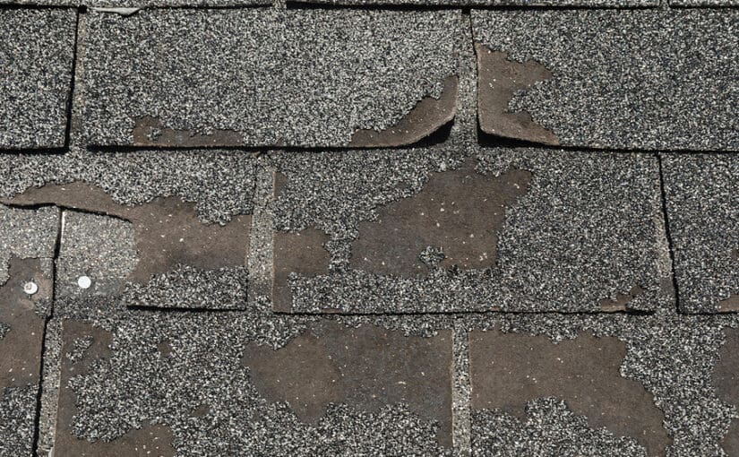 Roof in need of repair damaged asphalt roofing shingles architecture construction background texture pattern abstract concept
